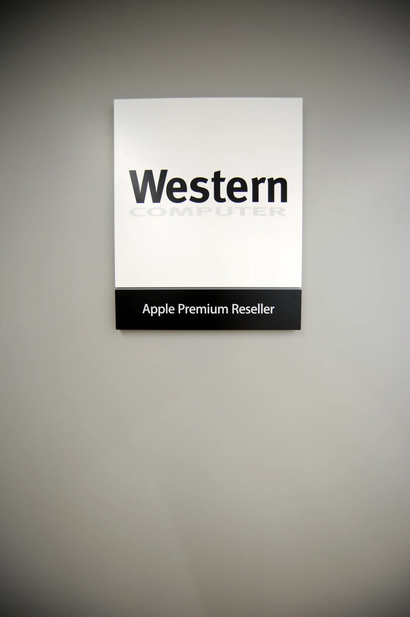 Western Apple Premium Reseller sign on a grey feature wall